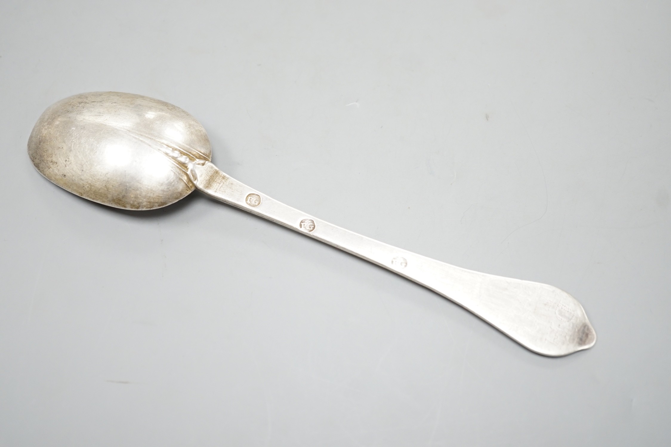 An early 18th century white metal rat tail dog nose spoon, stamped with maker's mark RG below two pellets three times, with prick dot initial and date, 20.6cm, 55 grams.